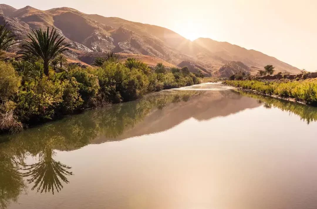 Río Draa con palmeras al atardecer